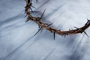 Crown of thorns casting a distinct shadow a white background, creating a symbolic easter image of suffering, sacrifice, and remembrance Copy good space friday for text