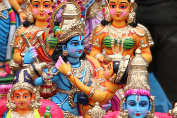 Colorful idols of Krishna and Radha are displayed for sale in a shop for the Golu festival