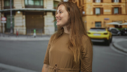 Fototapeta premium Woman smiling and giving thumbs up on city street in front of yellow car and building facade; confidence empowerment motivation.