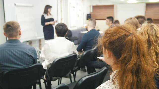 De-focused - a lot of people sitting at a seminar or lectures - background
