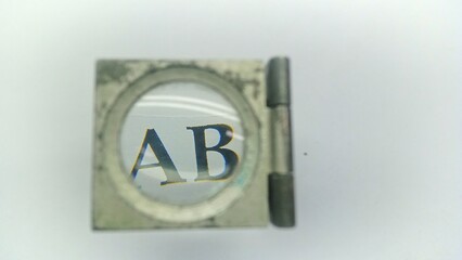Close-up of Optical Magnifier Zooming in on Alphabet Letters