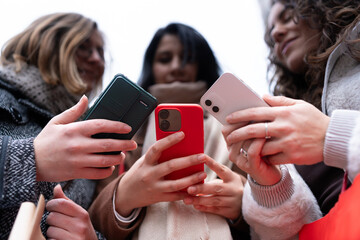 Friends enjoying city outing checking smartphones together