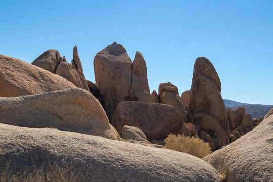 Jagged desert rock formations under bright midday sky