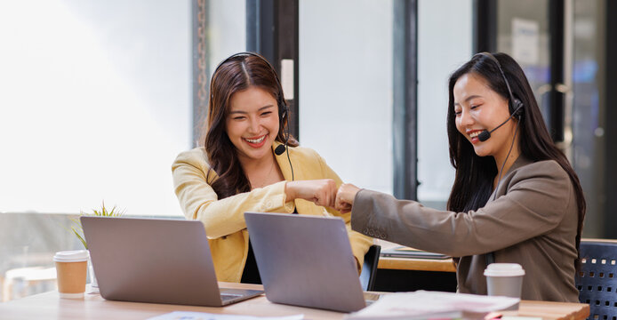 Customer support, women and employees with headset, office and working late with new system or above. Call center, supervisor and people with tech for software troubleshooting, training and night

