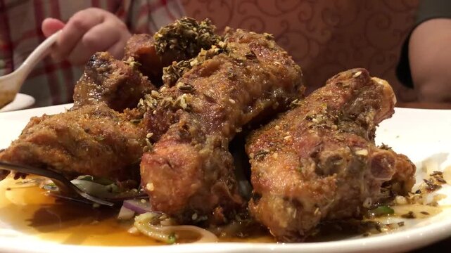 Authentic Chinese cuisine: Pile of salt and pepper spare ribs with herbs.