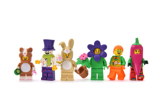 Lego minifigures of clown in purple cup and children as animals on carnival. Editorial illustrative image of holiday.