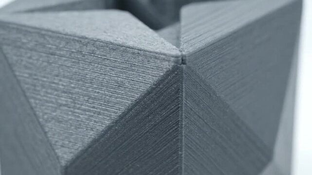 Close-up of stacked gray cardboard boxes with angled corners on a white background
