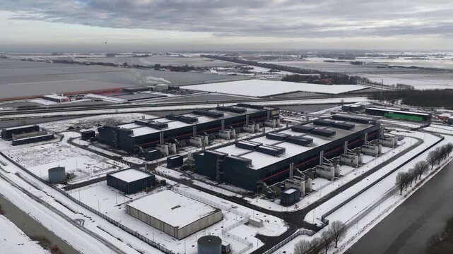 Aerial drone video of a large-scale computing and datacenter facility in winter, showcasing telecommunications infrastructure, server systems, and high-capacity digital operations.