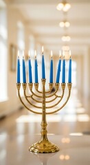 Gold hanukkah menorah with blue candles on table in bright hallway with white walls