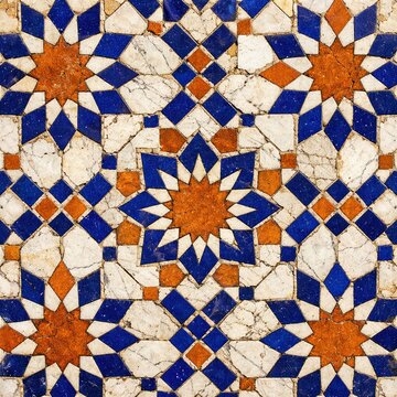 Traditional Islamic Geometric Mosaic Tile Pattern, Ornate Blue and Orange Star Design on Weathered White Marble, Antique Moroccan Arabesque Floor and Wall Ornament Texture Background.