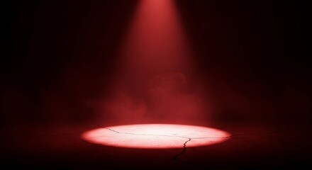 A single red spotlight shines brightly on a dark stage with smoke effects creating a dramatic atmosphere for performance