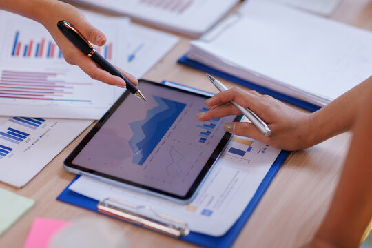 Hands and graphs on tablet screen for finance results, profit growth and budget review. Staff, team and digital with financial report, revenue stats and dividend comparison of risk assessment