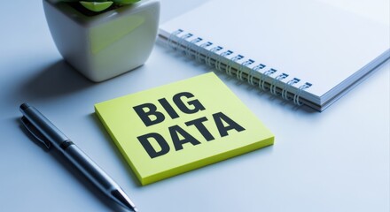 Big data concept on yellow notepad with pen, plant and spiral notebook on table