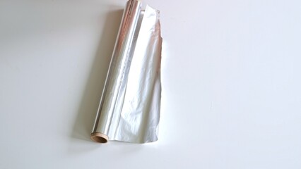 Roll of aluminum foil isolated on white background top view. High quality photo