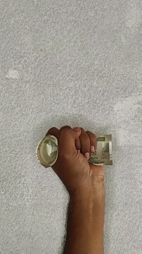 Indian angry person hand holding indian rupee currency banknote isolated on desk background with copy space. Demonetisation, recession, devaluation or unemployment concept. Closeup top view.