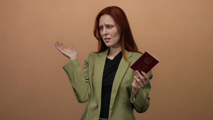 Woman holding chinese passport reacts to unpleasant smell with a disgusted expression against a...