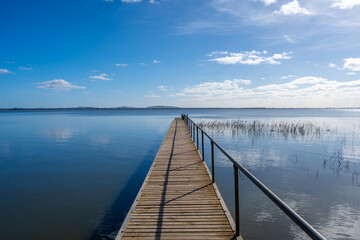 Obraz premium Wooden pier extending over Lake Colac, Victoria, Australia on a sunny day