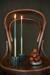  canel&eacute;s and candles in green candleholders canele's shape.