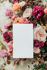 a white sheet of paper for writing on a background of flowers