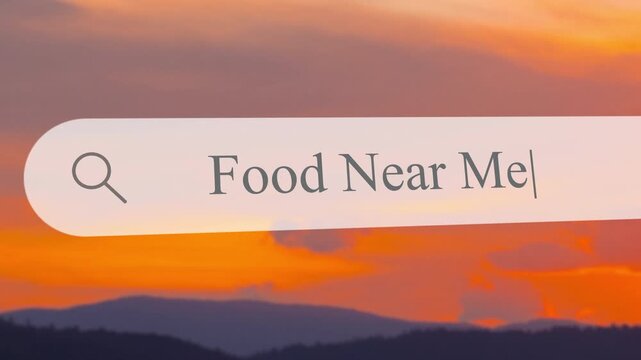 Typing in the search bar to find food nearby. Focus on locating options for meals in the area. Simple search process for local dining choices.