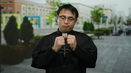 Man in religious attire with handcuffs stands on an urban street, creating a striking contrast...