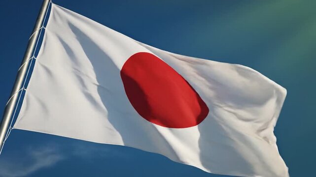 Japan's emblem of honor: The iconic flag of Japan flutters gracefully in the breeze against a backdrop of the sky. The Rising Sun emblem, a symbol of heritage, identity and national pride. 