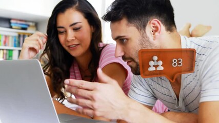 Animation of social media icon with growing number over caucasian couple using laptop - Powered by Adobe