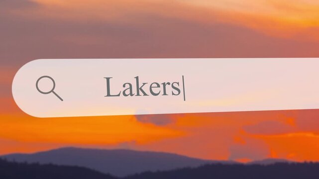 User types Lakers in the search box while enjoying a beautiful sunset over the mountains. The scene captures the calmness of nature during this evening moment.