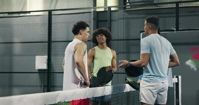 Padel, sports and friends talk at court about game, match and exercise tips for competition. Tennis players, happy group and discussion with men for fitness, tournament and chat for advice at club