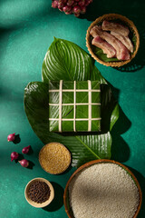 Chung cake with sticky rice and pork arranged on green background. Suitable for Tet food...