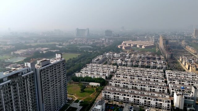 Drone panorama of Jaypee Greens, highlighting manicured golf greens, curving fairways, and premium residential blocks set within Noida&rsquo;s planned urban landscape. Row and Sports Villa