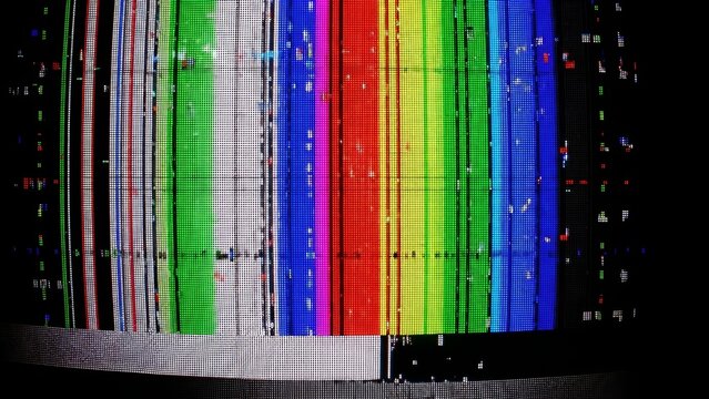 Distorted television screen displaying colorful test patterns with static interference