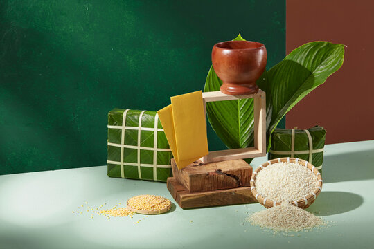 Vietnamese Chung cake paired with dong leaves, mung beans and sticky rice on green background. Suitable for Tet branding, hospitality visuals and food storytelling