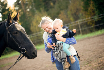 Laughing Mother And Toddler Near Horse