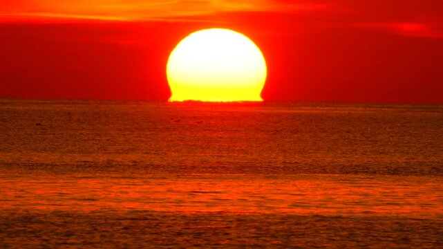 Sunset, ocean, sun, large vibrant red sun setting over the calm sea, beautiful majestic natural twilight