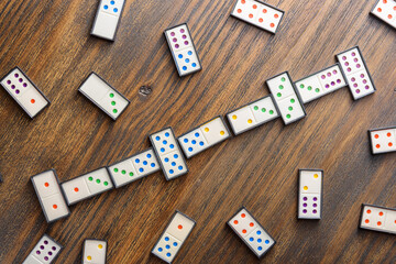 Playing dominoes at a wooden table for fun activity