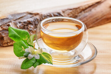 Jasmine green tea in clear cup on wooden table