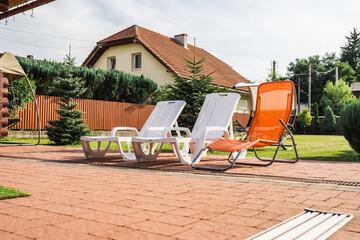 Garden chair at a swimming pool on a hot summer day.