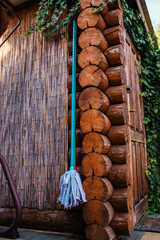 Garden wooden shed front view with mop on a corner.