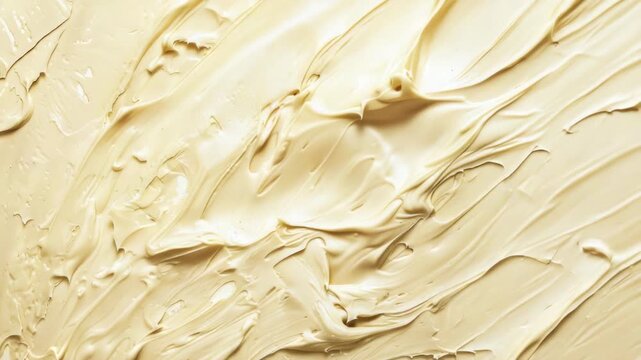 Close-up view of creamy beige texture with smooth, swirling patterns