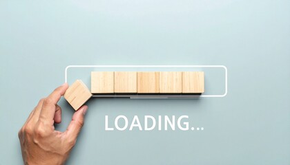 Hand placing wooden block into progress bar made of blocks, “LOADING...” text below on blue background.