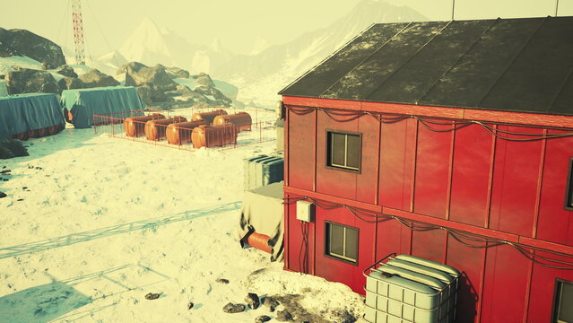 A striking red structure stands against a backdrop of white snow and rocky terrain. Fuel tanks are gathered nearby, hinting at human activity in this harsh wilderness.