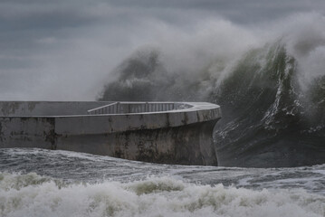 STORM AT SEA - Powerful waves of foaming sea water at the pier