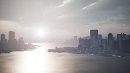 Obraz premium Golden sunlight breaks through clouds, reflecting off still waters. Towering buildings create a dramatic skyline. A serene yet vibrant scene unfolds as day transitions to night in the city.