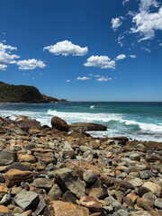 Beautiful day view at rocky beach shore.