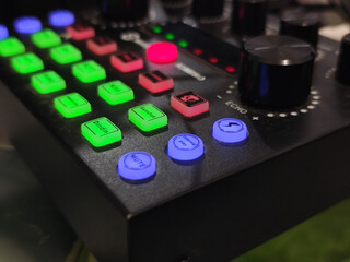 The soundcard is active with multicolored lights, photographed from close range.