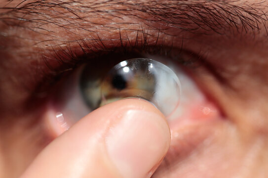 Close-up of a Woman putting a contact lens in her eye