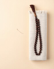Islamic Prayer Beads Tasbih Arranged on Textured Fabric for Devotional Use