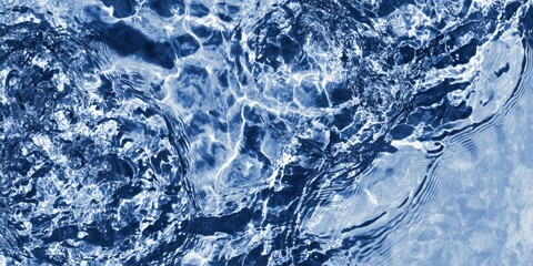 Rippling dark blue water surface displays intricate light refractions and dynamic movement