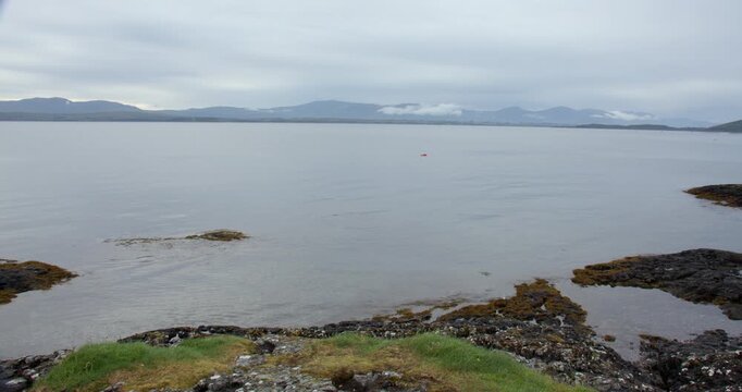 Extra wide shot of Ganavan Bay and Isle of Mull with black Highland midge at Oban